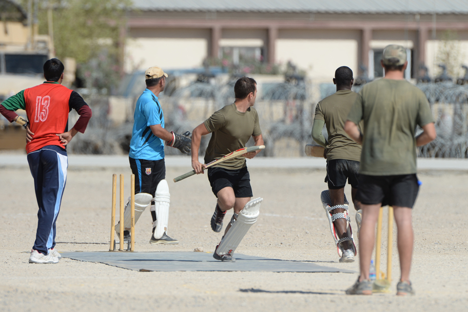 A member of the British Army side runs for the far wicket