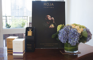 A display of ROJA PARFUMS packaging and promotional material at the British residence.