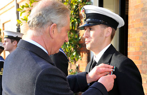 A member of the Commando Helicopter Force receives his Operational Service Medal for Afghanistan from His Royal Highness Prince Charles at Clarence House in London