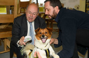 Lord Gardiner checks the microchip of Messi the dog