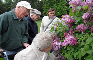 A group of people who are living with dementia enjoy a sensory experience in the great outdoors