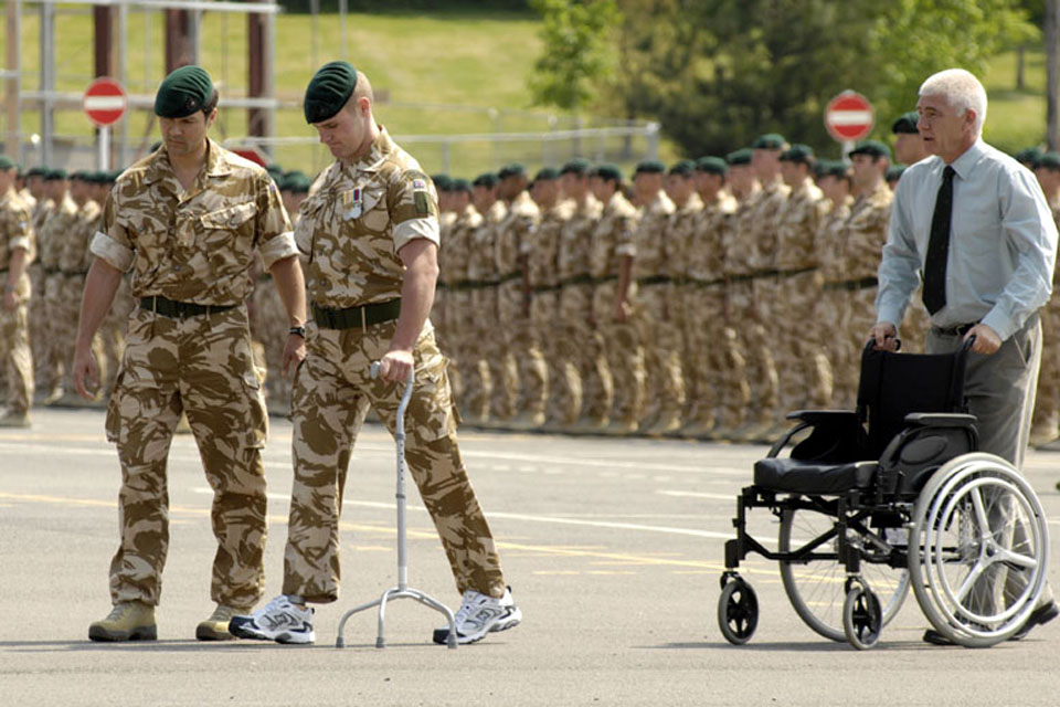 Marine Mark Ormrod, 40 Commando Royal Marines (second from left), receives his campaign medal following a six-month tour in Afghanistan's Helmand province on Operation HERRICK 7
