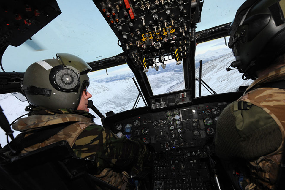 Admiral George Zambellas at the controls of a Commando Helicopter Force Sea King Mk4 helicopter during a flight over the Bardufoss training area