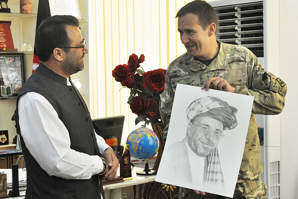 Brigadier Doug Chalmers presents the outgoing Governor of Helmand province, Gulab Mangal, with a portrait