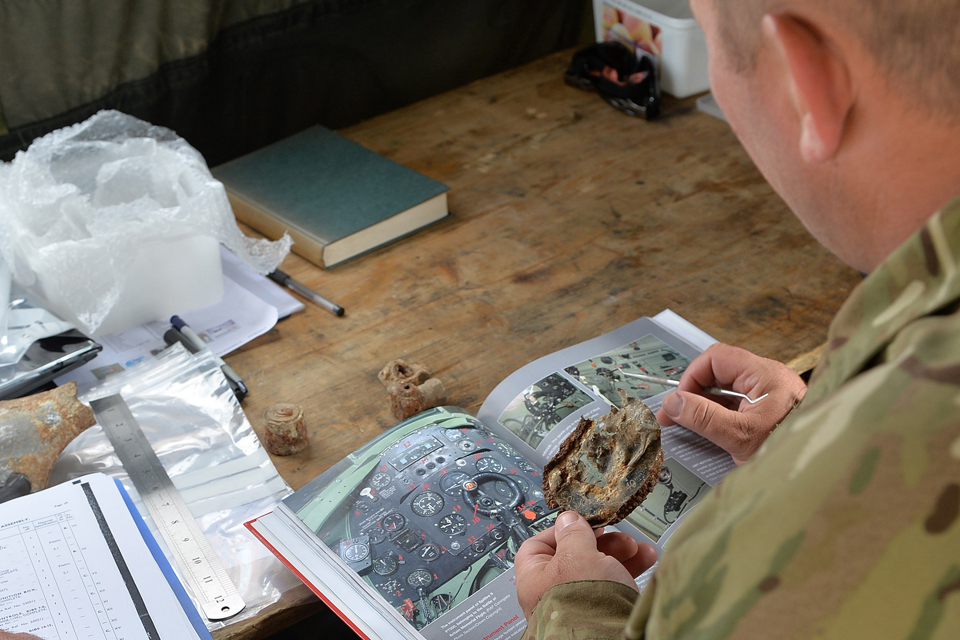 A soldier tries to identify a part of MK1a Spitfire P9503 