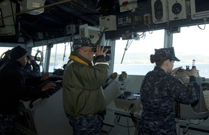 Captain Robert Hein of the United States Navy looks out from the bridge of the guided-missile cruiser USS Gettysburg