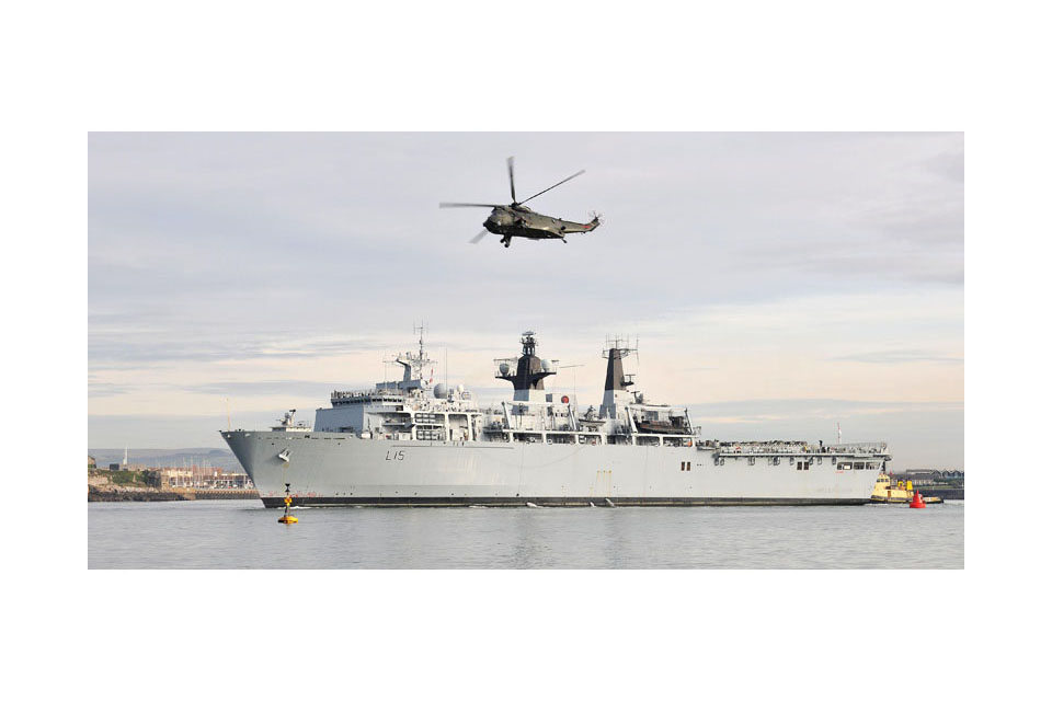 Sea King helicopter flies over HMS Bulwark