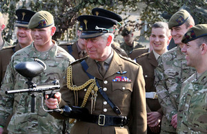 His Royal Highness The Prince of Wales fires a paintball gun during his visit to the 1st Battalion Welsh Guards at their barracks in Hounslow, Middlesex [Picture: Steve Parsons/PA Wire 2012]