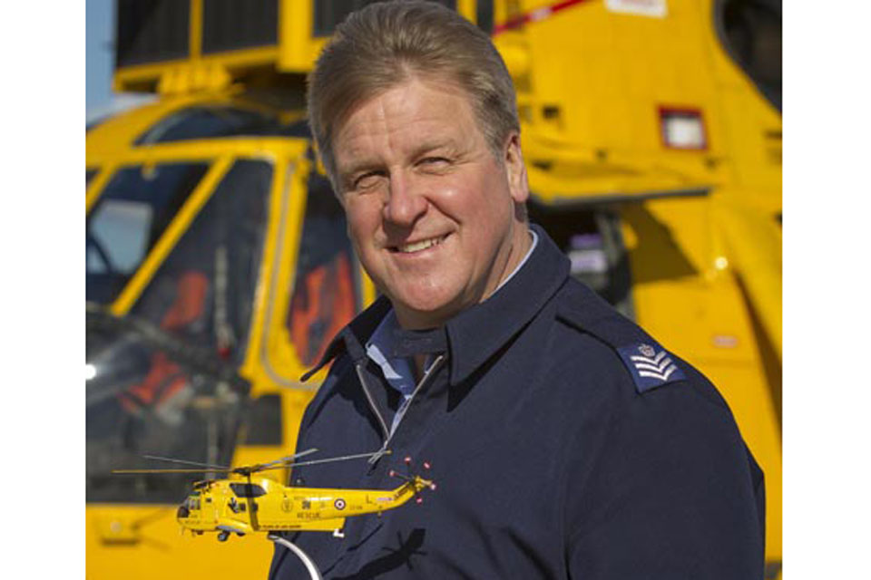 Flight Sergeant Andy Carnall, designer of the RAF Search and Rescue Force's 70th anniversary aircraft decal, with one of the Corgi model helicopters