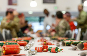 Troops enjoying a Christmas dinner with crackers