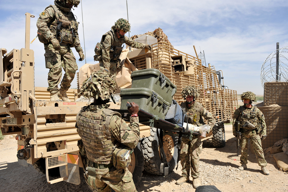 Soldiers load a Wolfhound vehicle with equipment