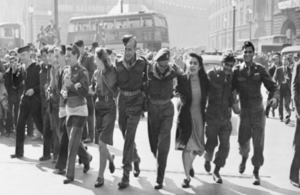 Civilians and service personnel in London's Piccadilly Circus celebrate the news of Allied Victory over Japan in August 1945