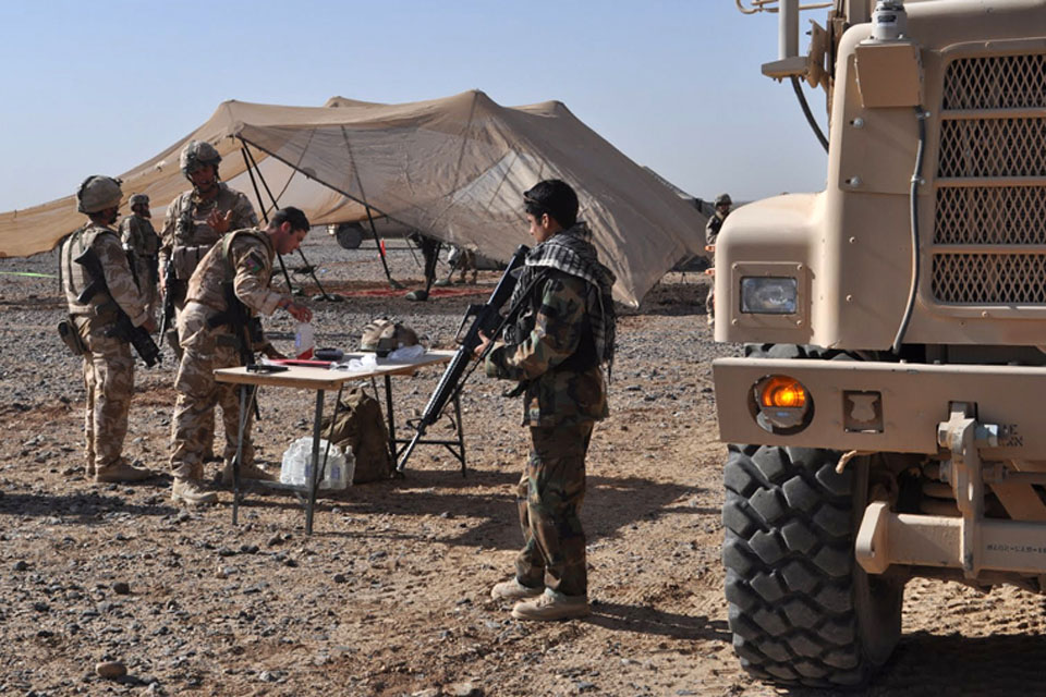 Afghan National Army soldiers and gunners from No 1 Squadron RAF Regiment set up a reception area for a primary health care clinic at the village of Habibabad