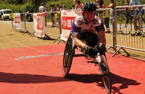 Joe Townsend crosses the finish line in his racing wheelchair at the Cotswold 113 event - a half Iron Man race