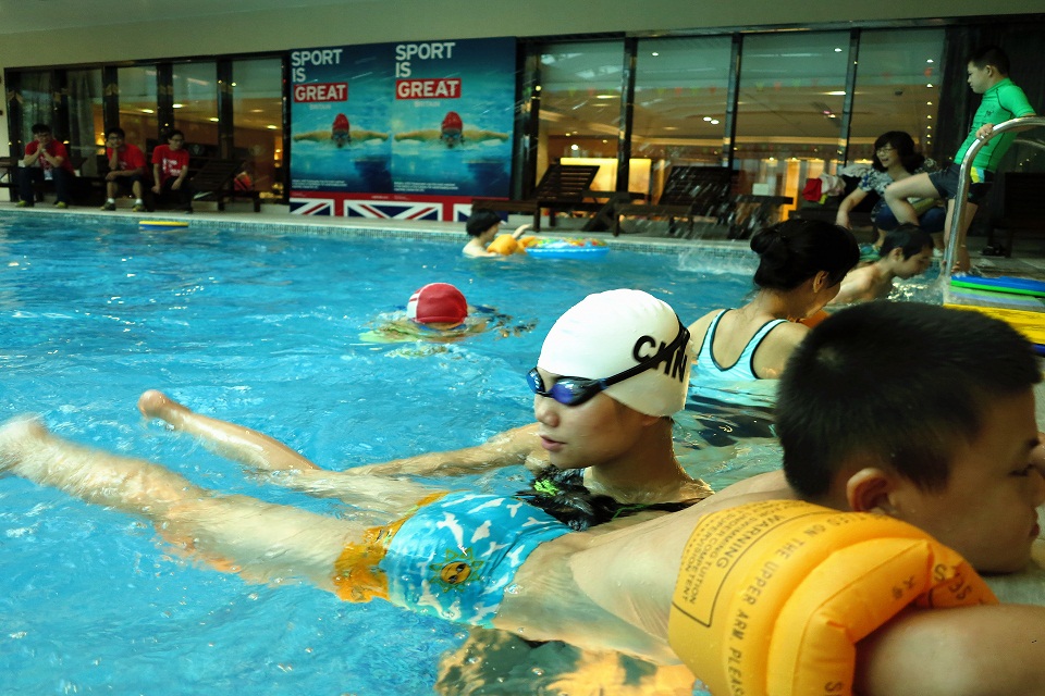 Ms Lin Ping, 2012 Paralympic swimming gold medalist coaching special needs children how to swim at the anniversary event. 