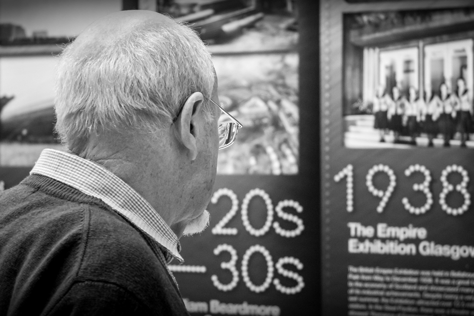 Older man looking at Glasgow art exhibition