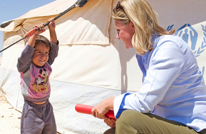 International Development Secretary Justine Greening meeting a Syrian refugee boy in Jordan. Picture: Scott Hornby/Sun