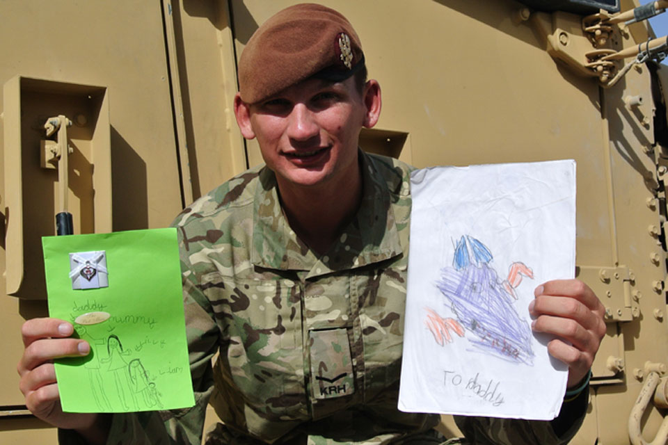 Lance Corporal Thomas Cook with Father's Day cards from his wife, Lucy, and two children