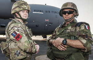 A member of the RAF Police and a French serviceman stand guard whilst the C-17 is unloaded at Bangui Airport [Picture: Corporal Neil Bryden RAF, Crown copyright]