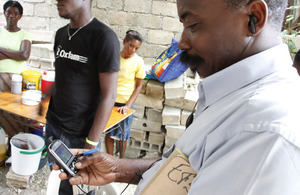 An aid worker uses a mobile phone in Haiti after the 2010 earthquake. Picture: Russell Watkins/DFID