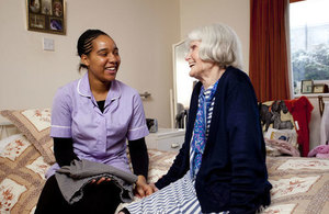 A social worker assisting an older lady.