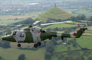 A Lynx helicopter flies over Glastonbury Tor
