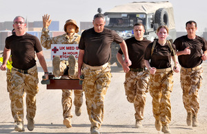 Medics taking part in the stretcher-carry around Camp Bastion to raise money for Service charities