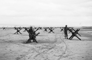 Royal Navy commandos preparing to demolish obstacles on one of the Normandy beaches [Picture: Imperial War Museum]