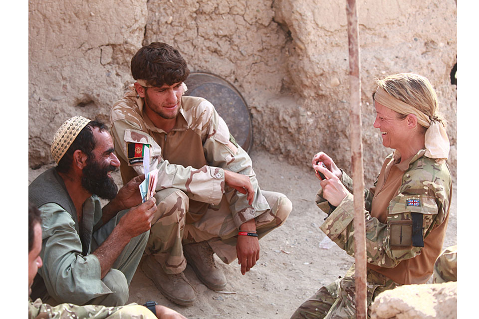 Sergeant Karen Swallow RAF engages with local Afghans while attached to Royal Marines of J Company, 42 Commando, in Helmand province 