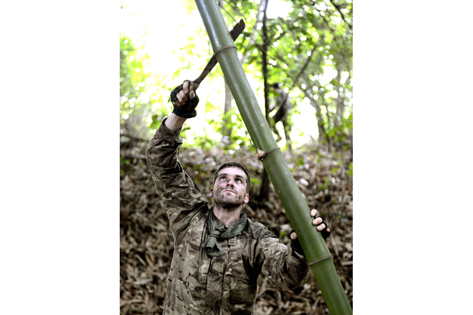 A Royal Marines commando cuts bamboo