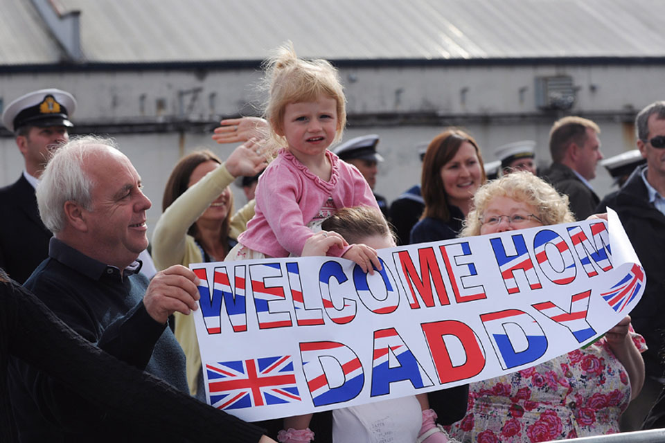 Families and friends wait to welcome home their loved ones as HMS Grimsby returns to her home port of HM Naval Base Clyde 