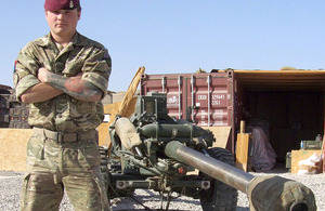 Gunner Jonathan Long poses alongside an L118 Light Gun in southern Afghanistan