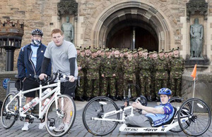 Cyclists Rifleman Michael Paul Jacobs and his brother, and Rifleman Michael Swain, in front of Edinburgh Castle at the start of the Ride of Britain