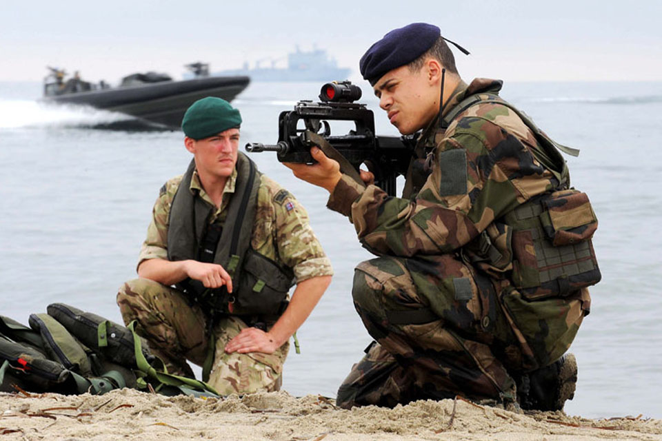 A Royal Marine and a French Marine ready for action after being inserted onto a beach during Exercise Corsican Lion