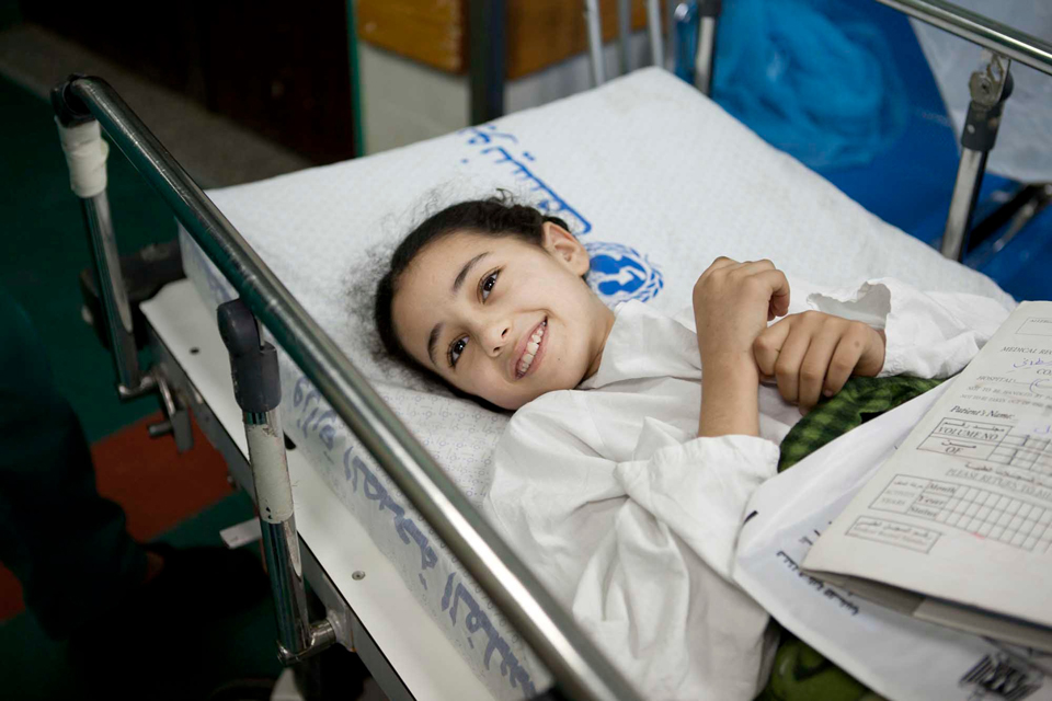 9-year-old Weam smiles as she waits to have an operation on her injured leg in Gaza's Shifa hospital. Picture: Abbie Trayler-Smith/Panos for DFID