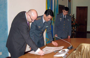 UK MOD representative Mr Derek Sturge signs the Military Cooperation Plan for 2014 with Lieutenant Colonel Nurmashev in the Kazakh MOD