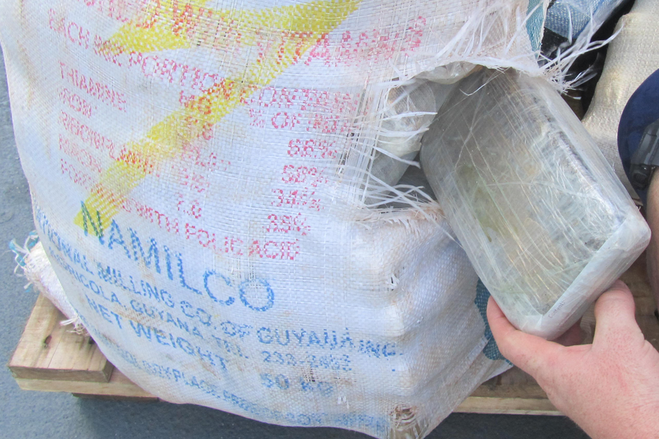 Packages of marijuana being sorted and weighed