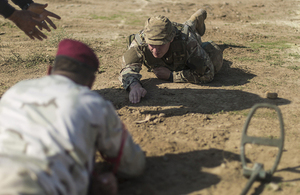 A British soldier teaches an Iraqi soldier how to expose an improvised explosive device during breaching training. Combined Joint Task Force - Operation Inherent Resolve Copyright.