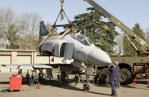 The team carefully lift the Phantom's fuselage away from the wings