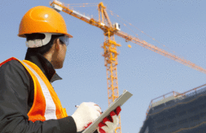 Picture of hard hat work on site with crane.