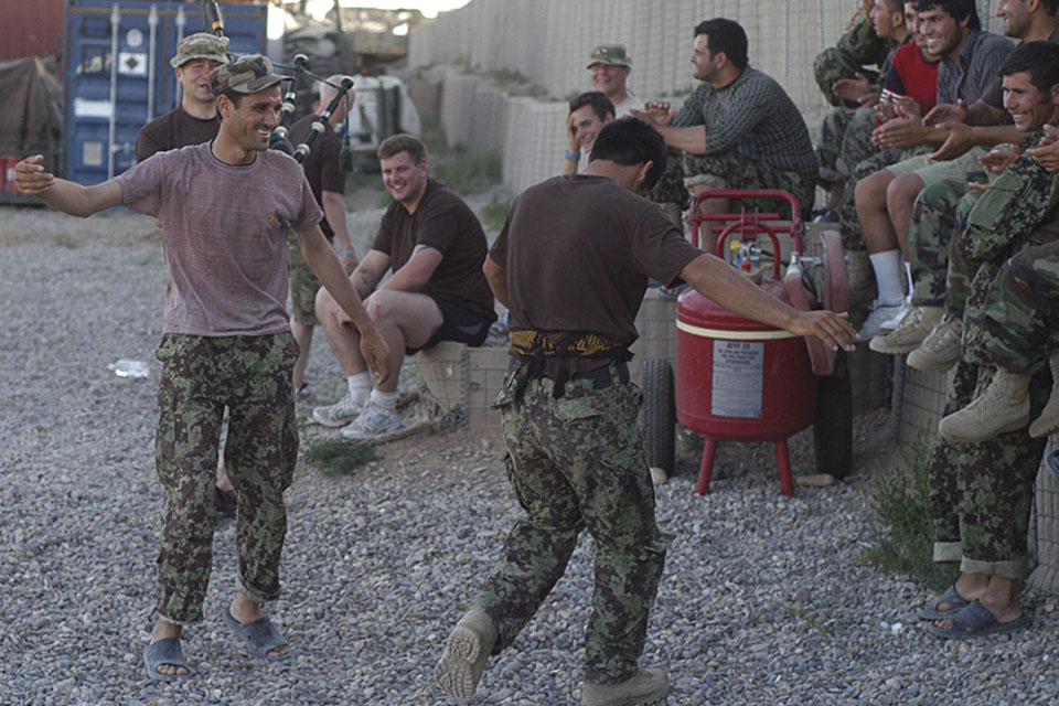 Soldiers from 4th Battalion The Royal Regiment of Scotland teach their Afghan National Army colleagues how to do the Highland Fling ahead of the volleyball tournament at Patrol Base Nahidullah 