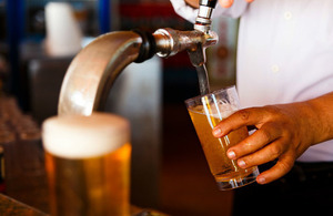 Bar person pulling a pint of beer.