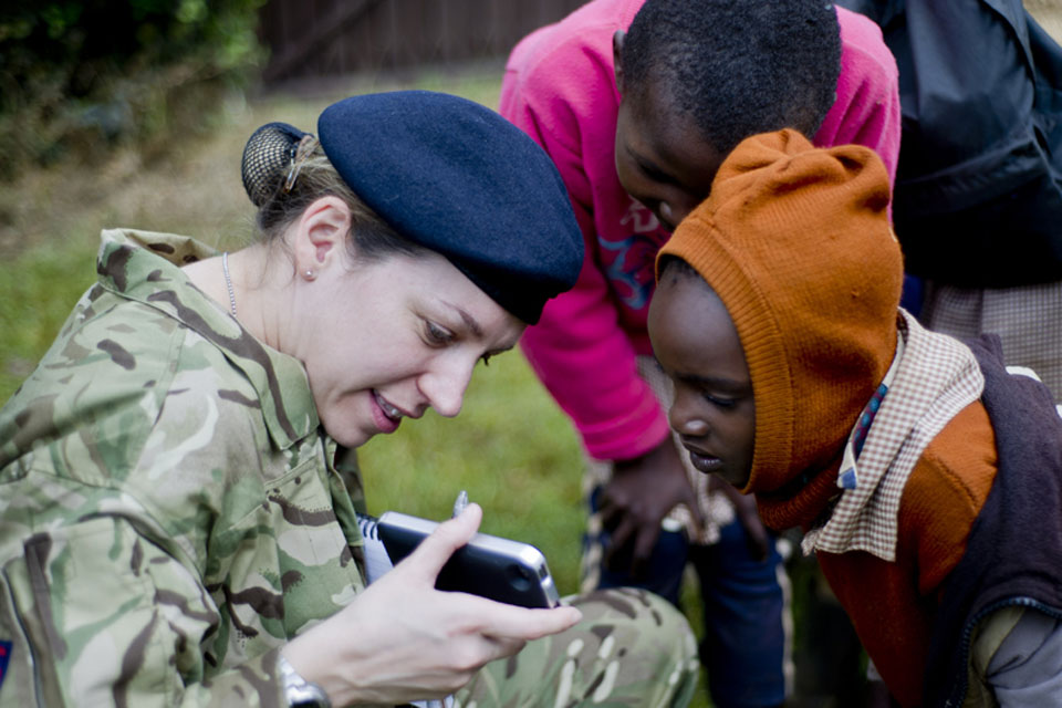 Captain Martha Fairlie of the Military Stabilisation Support Group chats with local children in Kenya