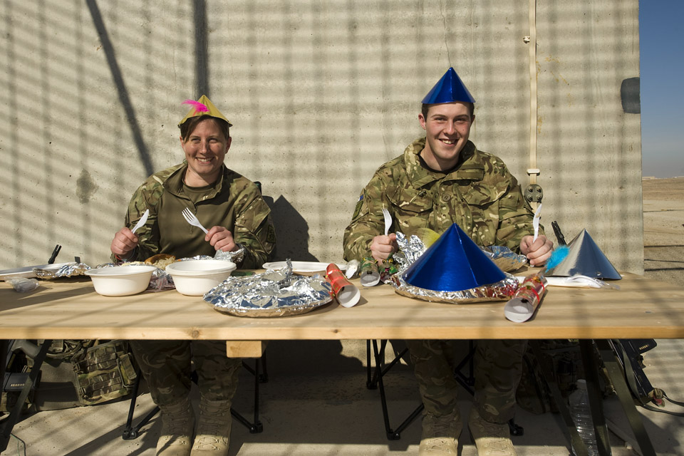 Flight Lieutenant Leah Parle from Banbury (left) and Signaller Alex Williams from Newport, enjoying Christmas Dinner in Camp Bastion.