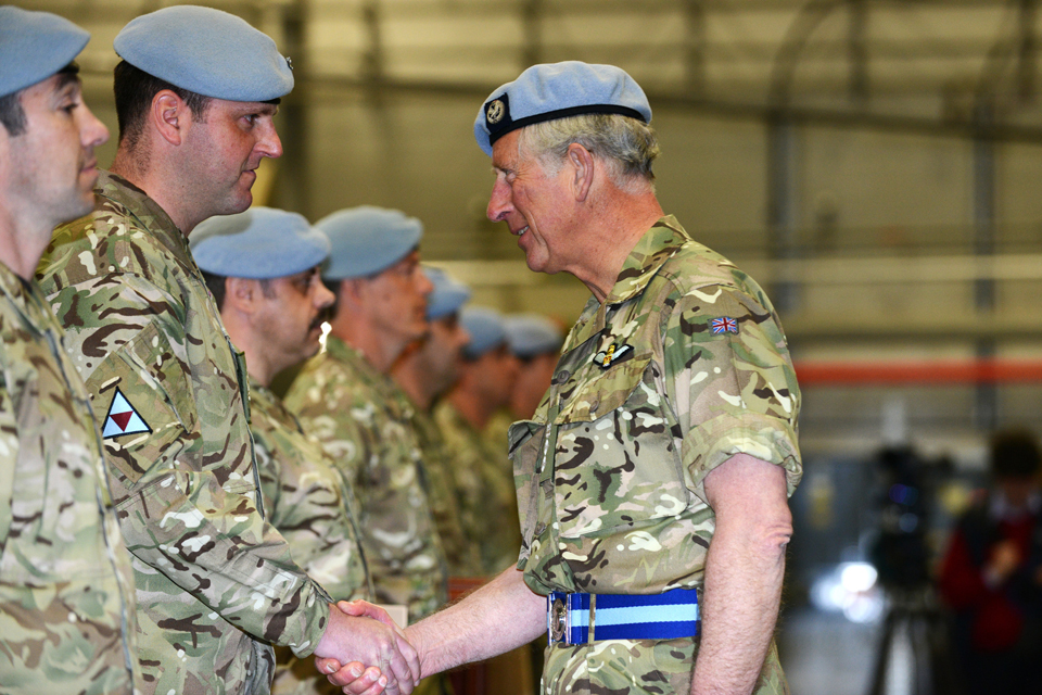 Prince Charles shakes hands with a member of the Army Air Corps