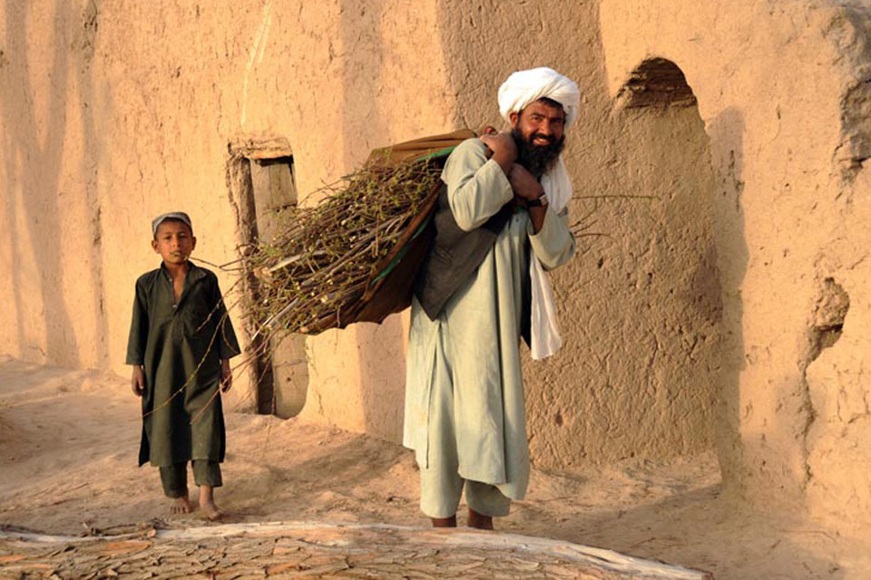 British soldier works with Afghan villagers to improve their lives