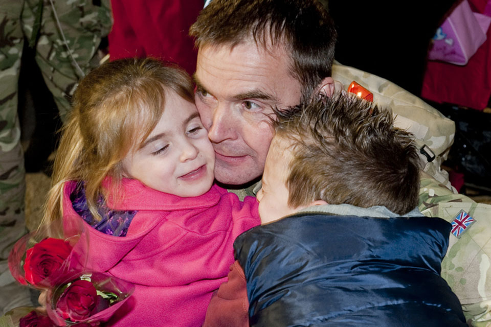An airman of 12(B) Squadron is greeted by his children