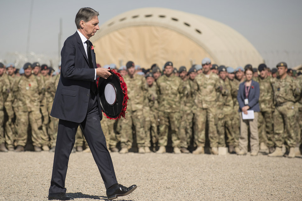 The Defence Secretary lays a wreath during the remembrance service held at Camp Bastion