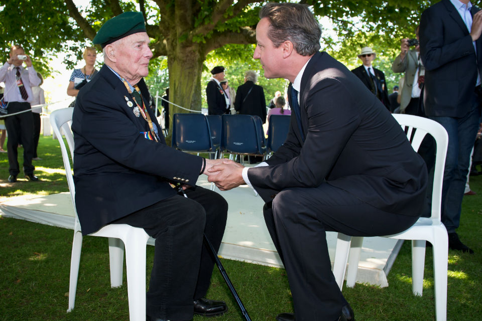 The Prime Minister with a veteran at Bayeux Cemetery.