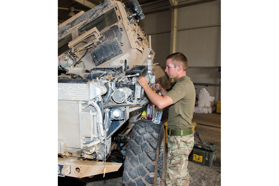 A mechanic works on a Foxhound armoured vehicle